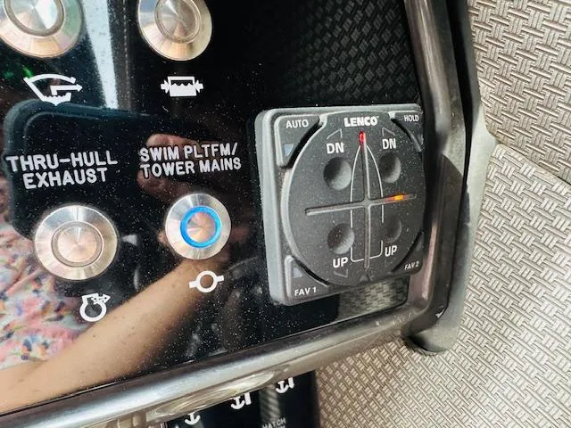 Slide: The Image of Control panel of a 2016 Sea Ray 250 SLX boat with Lenco trim tab switches. - 25