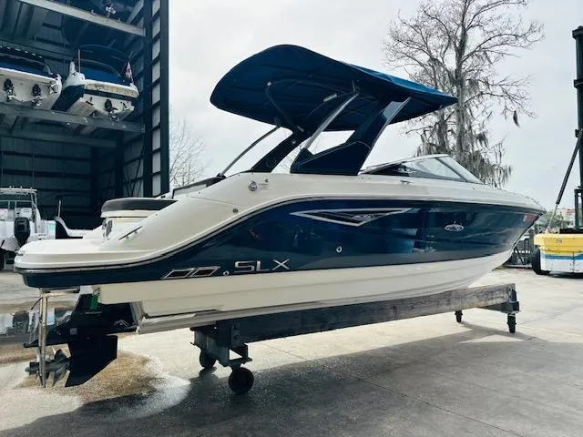 Slide: The Image of 2016 Sea Ray 250 SLX boat on a lift, featuring sleek design and blue accents. - 6
