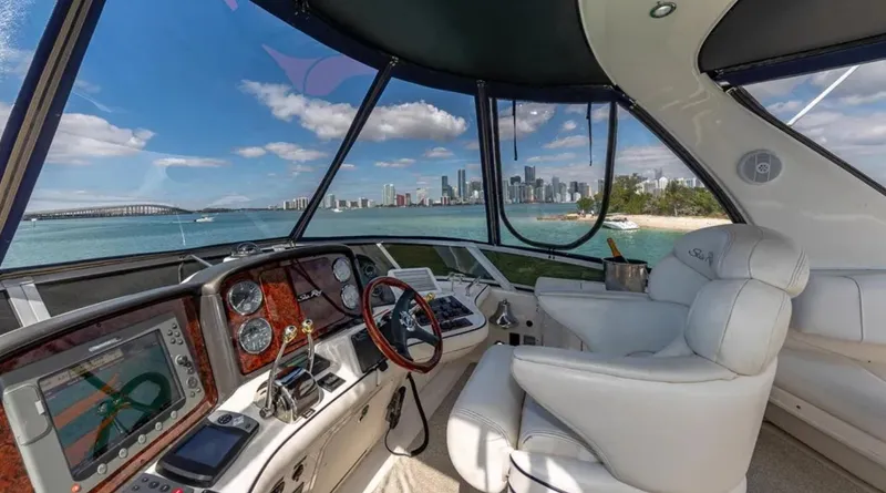 Slide: The Image of 2006 Sea Ray 44 Sedan Bridge cockpit with city skyline view. - 1