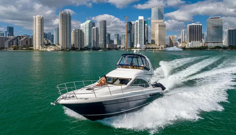 Slide: The Image of 2006 Sea Ray 44 Sedan Bridge cruising in front of a city skyline on a sunny day. - 11