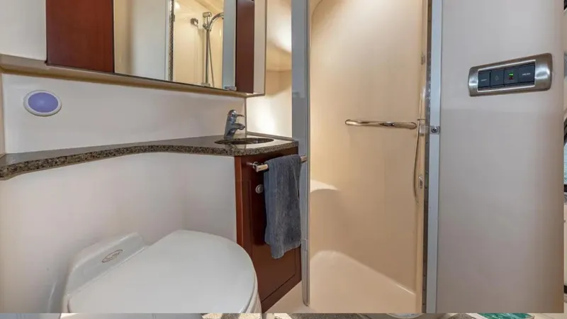Slide: The Image of 2006 Sea Ray 44 Sedan Bridge bathroom with shower, sink, and toilet. - 5