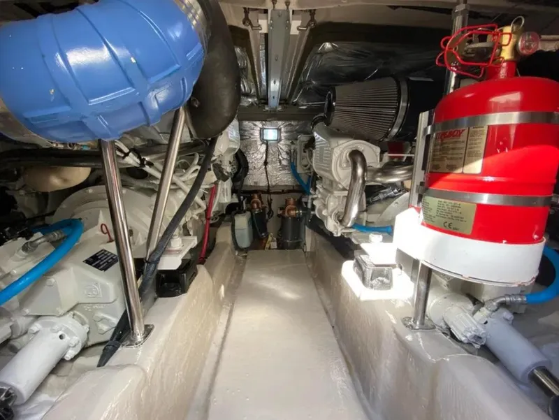 Slide: The Image of Engine room of 2006 Sea Ray 44 Sedan Bridge with visible machinery and fire extinguisher. - 6