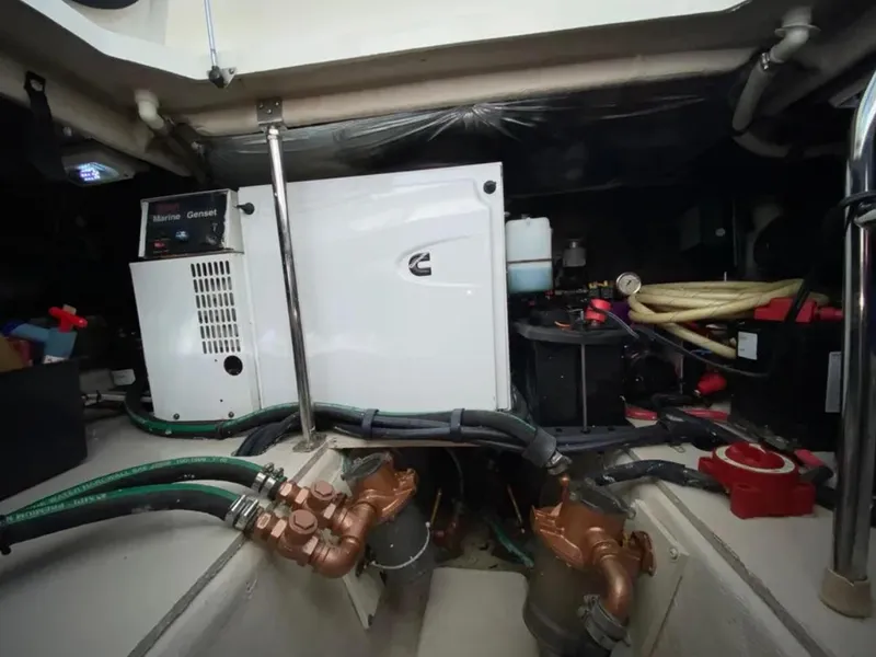 Slide: The Image of Engine room of 2006 Sea Ray 44 Sedan Bridge with generator and piping. - 8