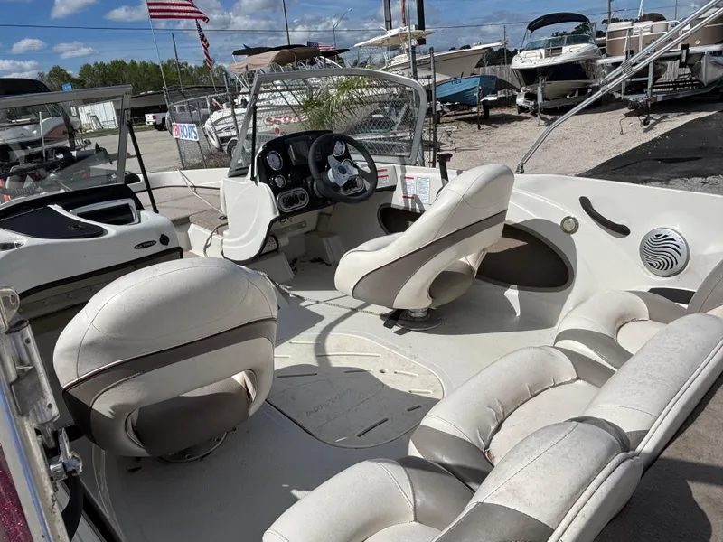 Slide: The Image of 2015 Nitro Z-7 Sport boat interior with beige seating and steering console. - 18