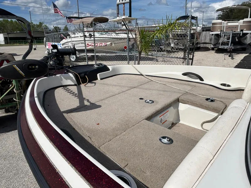 Slide: The Image of 2015 Nitro Z-7 Sport boat interior with fishing deck and motor, parked outdoors. - 20