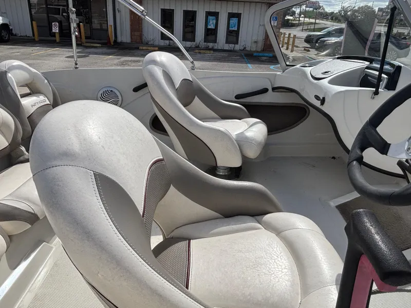 Slide: The Image of Interior of a 2015 Nitro Z-7 Sport boat with white and gray seating. - 9
