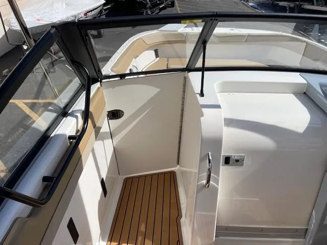 Slide: The Image of 2025 Bayliner TROPHY 22 SC boat interior with wood flooring and sleek design. - 10