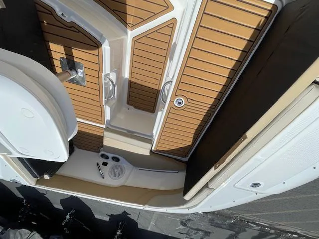 Slide: The Image of 2025 Bayliner TROPHY 22 SC boat deck with wood finish and storage compartments. - 20