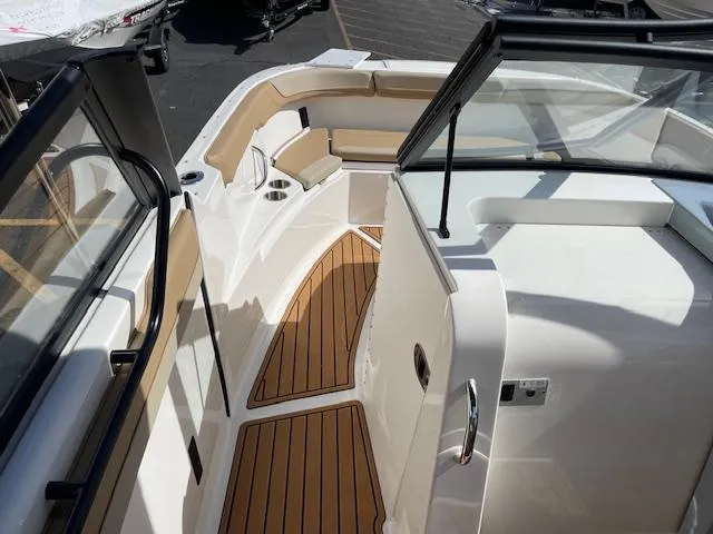 Slide: The Image of 2025 Bayliner TROPHY 22 SC boat interior with wood accents and seating. - 22