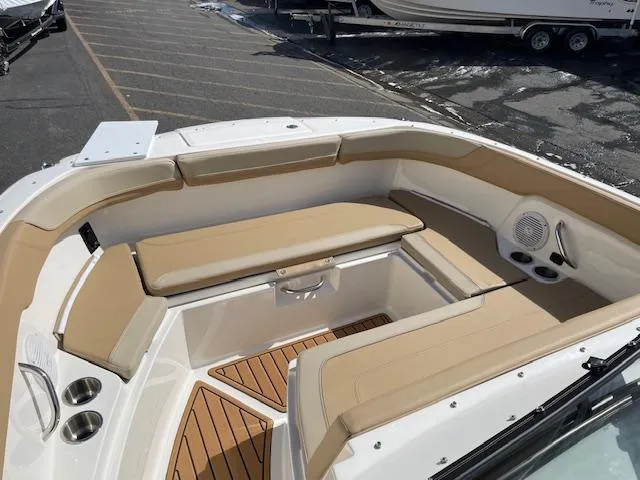 Slide: The Image of 2025 Bayliner TROPHY 22 SC boat interior with tan seating and wood accents. - 26