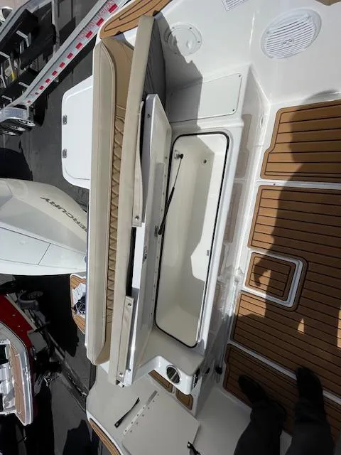 Slide: The Image of 2025 Bayliner TROPHY 22 SC boat interior with seating and storage compartments. - 30