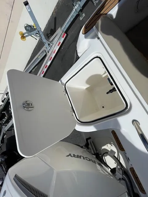 Slide: The Image of 2025 Bayliner TROPHY 22 SC boat with open storage compartment and Mercury engine. - 46