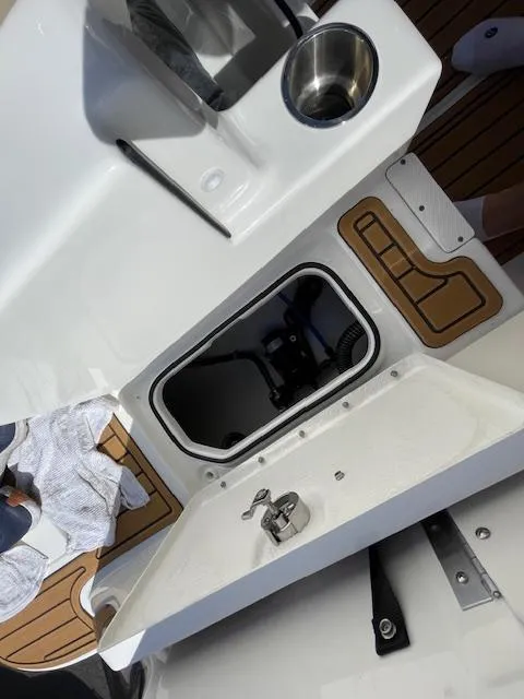 Slide: The Image of 2025 Bayliner TROPHY 22 SC boat interior with storage compartment and cup holder. - 49