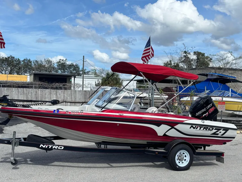 Slide: The Image of 2014 Nitro Z-7 boat with 150 L OptiMax Pro XS, red canopy, on trailer. - 10