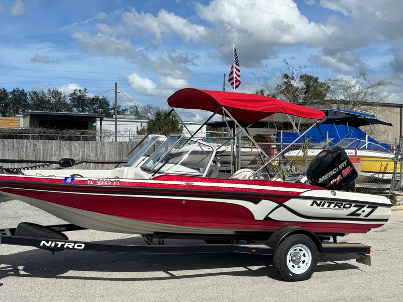 Slide: The Image of 2014 Nitro Z-7 boat with 150 L OptiMax Pro XS, red canopy, on trailer. - 11
