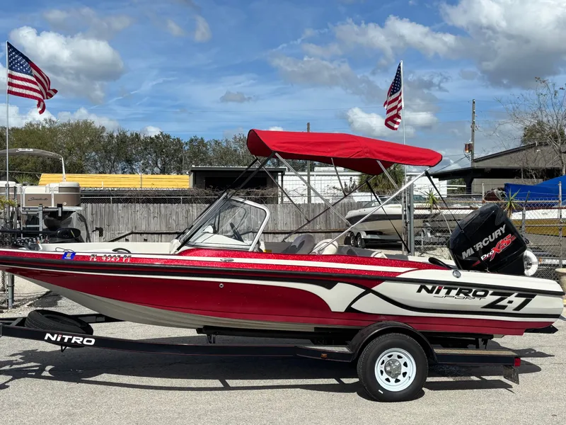 Slide: The Image of 2014 Nitro Z-7 boat with 150 L OptiMax Pro XS, red canopy, on trailer. - 12