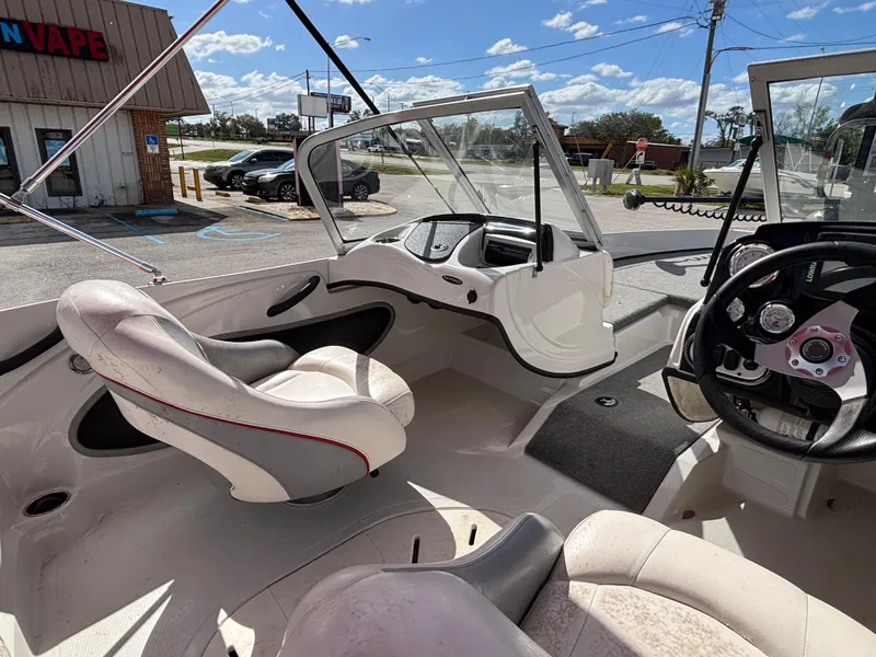 Slide: The Image of Interior of 2014 Nitro Z-7 boat with steering wheel and seating, parked outdoors. - 16