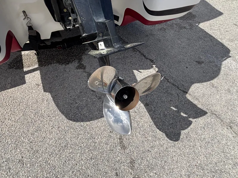 Slide: The Image of 2014 Nitro Z-7 boat propeller and motor on trailer, parked on pavement. - 23