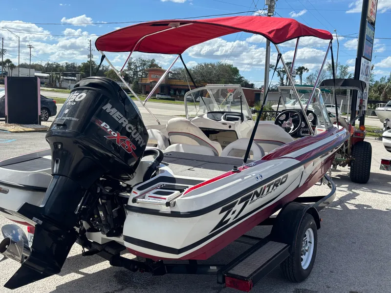Slide: The Image of 2014 Nitro Z-7 boat with 150 L OptiMax Pro XS engine and trailer, red canopy. - 4
