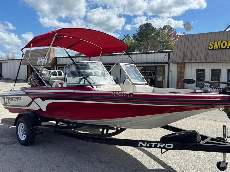 Slide: The Image of 2014 Nitro Z-7 boat with 150 L OptiMax Pro XS, red canopy, on trailer. - 6