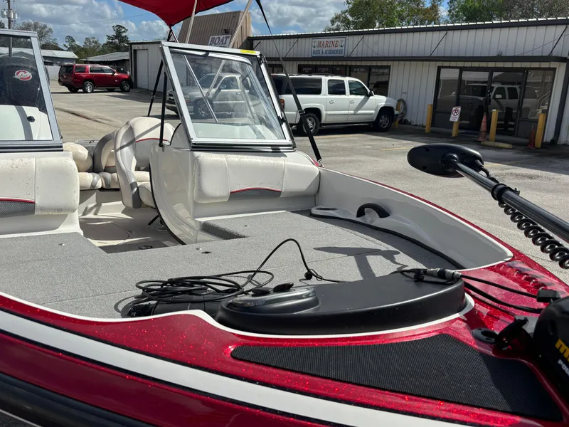 Slide: The Image of 2014 Nitro Z-7 boat with trailer, featuring open deck and seating, parked outdoors. - 8