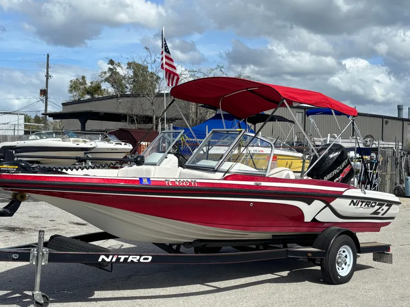 Slide: The Image of 2014 Nitro Z-7 boat with 150 L OptiMax Pro XS, red canopy, on trailer. - 9