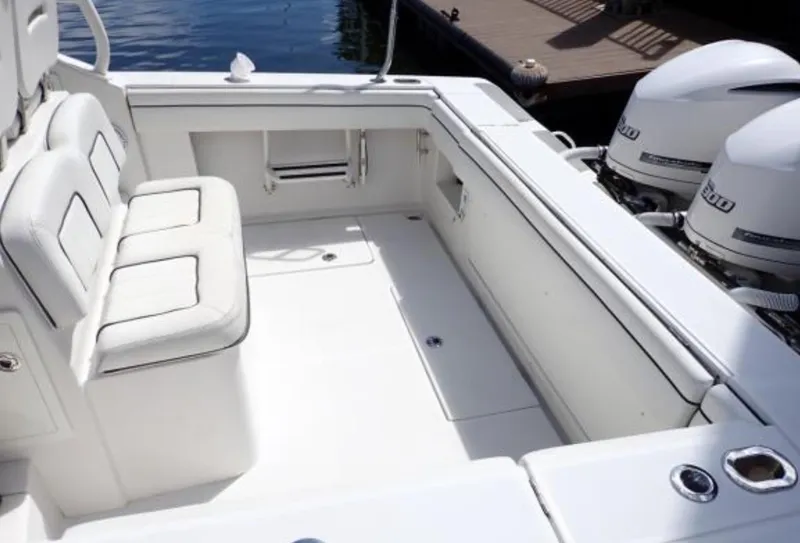 Slide: The Image of 2016 Jupiter 34 LX boat interior with seating and dual outboard engines. - 15