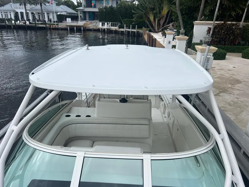 Slide: The Image of 2016 Jupiter 34 LX boat docked, featuring spacious seating and sleek design. - 5