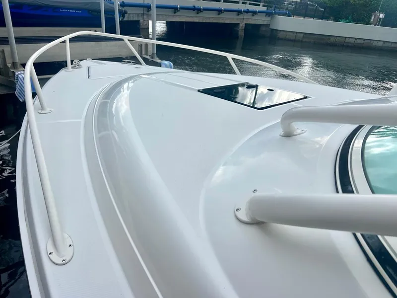 Slide: The Image of 2016 Jupiter 34 LX boat deck, docked by the water. - 6