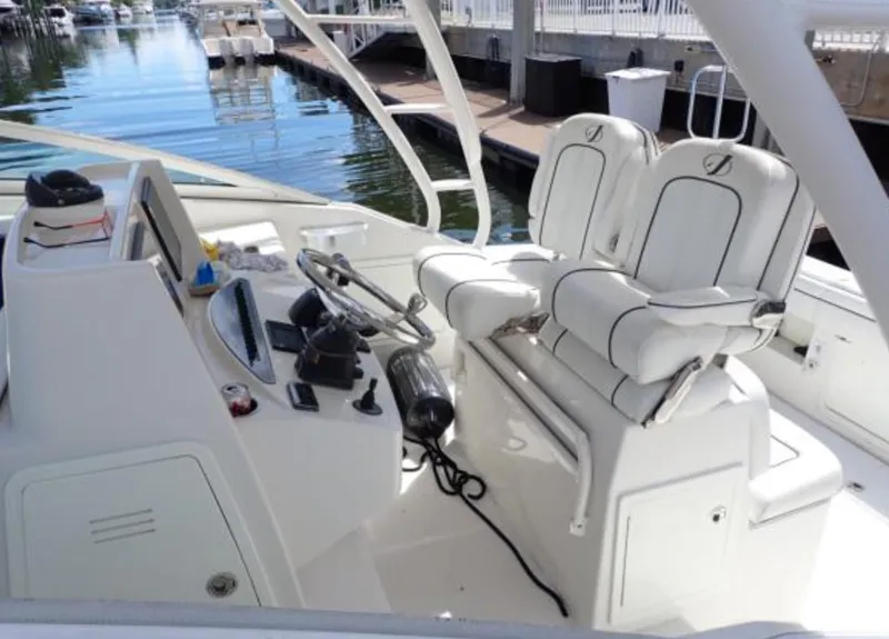 Slide: The Image of 2016 Jupiter 34 LX boat cockpit with dual seats and control panel. - 8