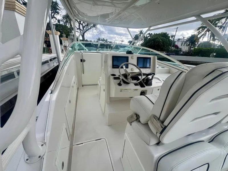 Slide: The Image of 2016 Jupiter 34 LX boat interior with helm, steering wheel, and seating. - 9