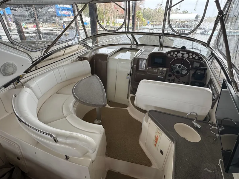 Slide: The Image of 2005 Regal 3560 Commodore yacht interior with white seating and helm station. - 11