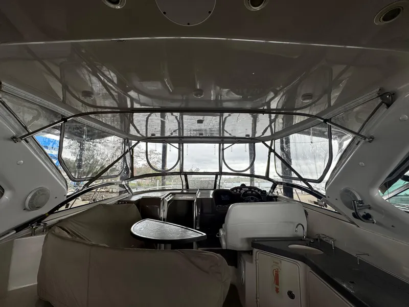 Slide: The Image of Interior view of 2005 Regal 3560 Commodore yacht, featuring helm and seating area. - 14