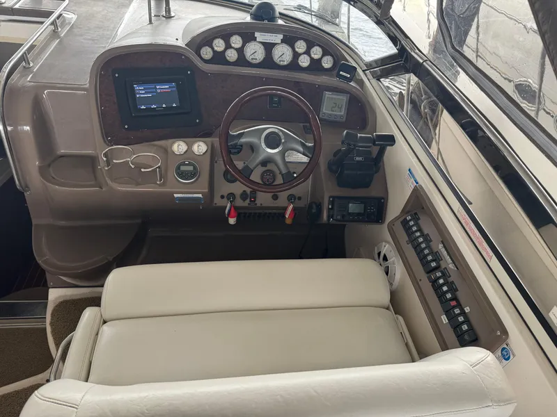 Slide: The Image of 2005 Regal 3560 Commodore boat cockpit with steering wheel and control panel. - 16