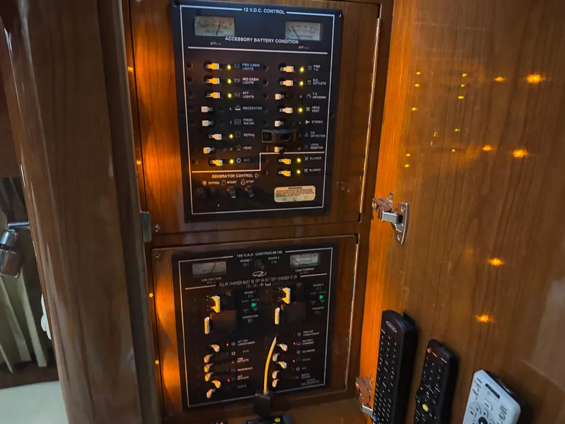 Slide: The Image of Control panel inside 2005 Regal 3560 Commodore yacht, featuring illuminated switches and remotes. - 29
