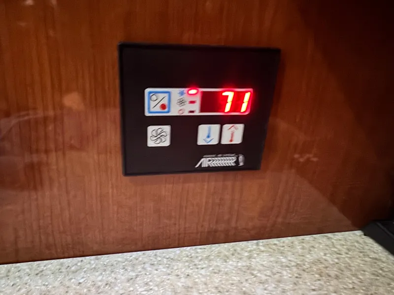 Slide: The Image of Control panel displaying temperature at 71 degrees on 2005 Regal 3560 Commodore yacht. - 31