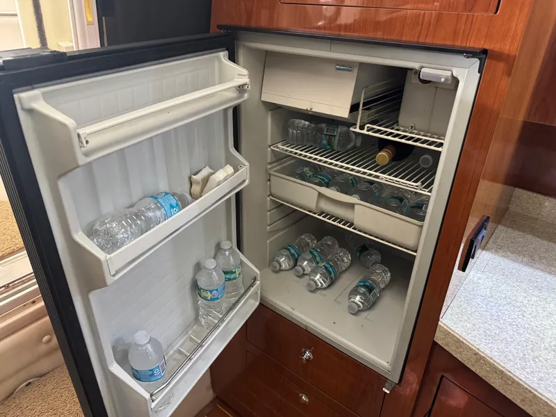 Slide: The Image of Open mini fridge in 2005 Regal 3560 Commodore, stocked with water bottles. - 33