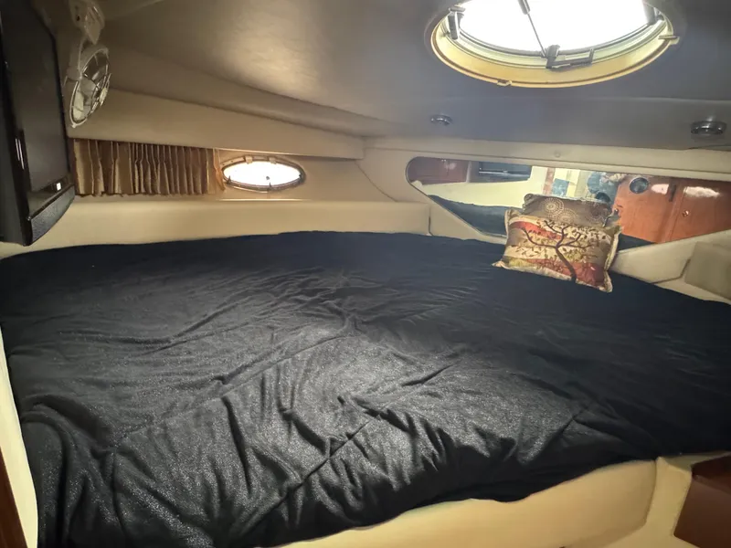 Slide: The Image of 2005 Regal 3560 Commodore cabin interior with bed and porthole windows. - 36