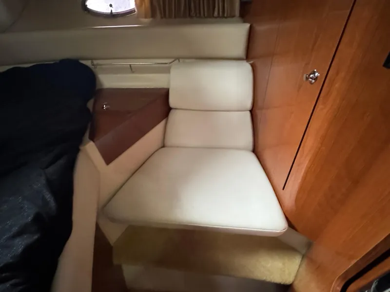 Slide: The Image of 2005 Regal 3560 Commodore cabin interior with cushioned seating and wooden cabinetry. - 38