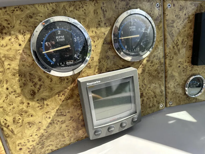 Slide: The Image of Dashboard of 2006 Formula 40 PC boat with RPM gauges and Raymarine display. - 19