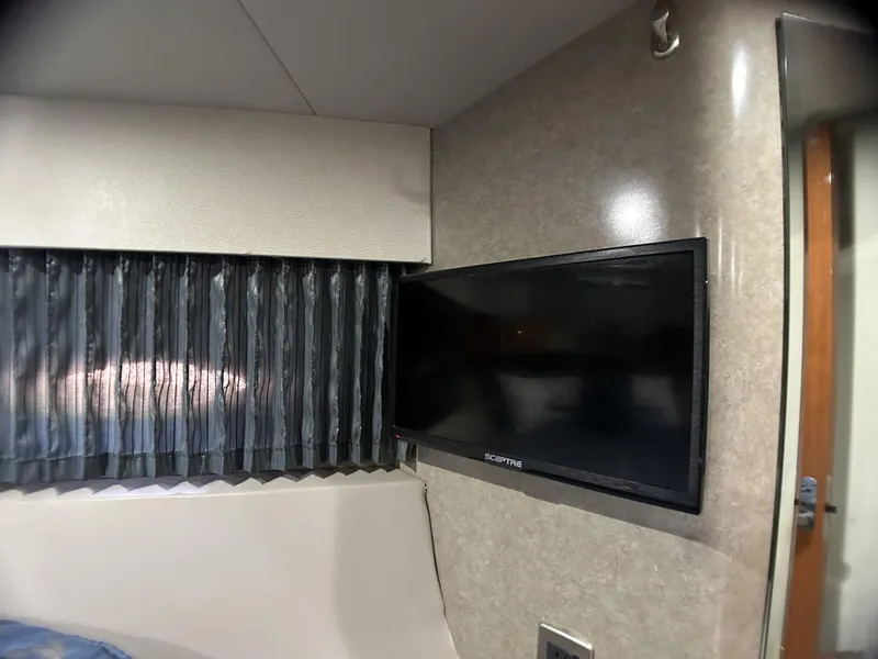 Slide: The Image of 2006 Formula 40 PC interior with mounted TV and window curtains. - 26