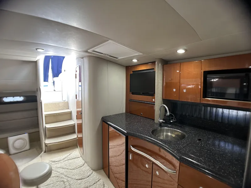 Slide: The Image of Interior of 2006 Formula 40 PC yacht with modern kitchen and stairs to deck. - 27