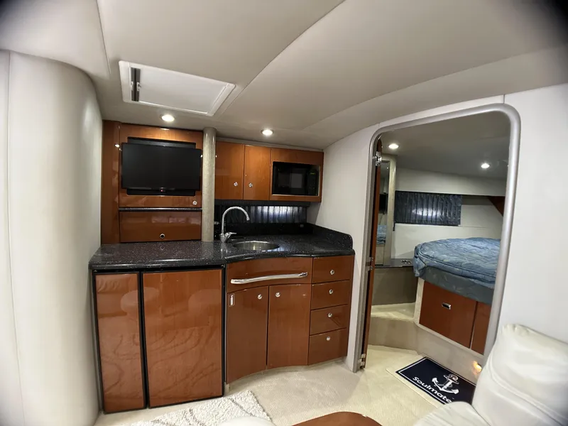Slide: The Image of 2006 Formula 40 PC yacht interior with kitchenette, TV, and cozy sleeping area. - 47