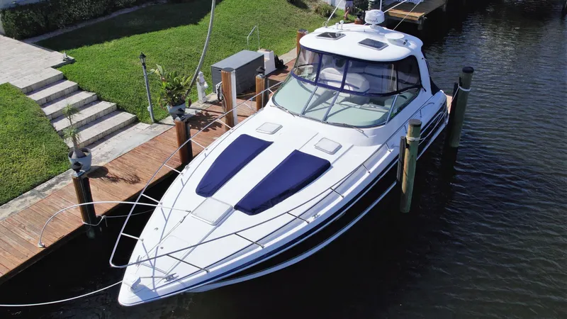 Slide: The Image of 2006 Formula 40 PC yacht docked in a serene marina setting. - 5