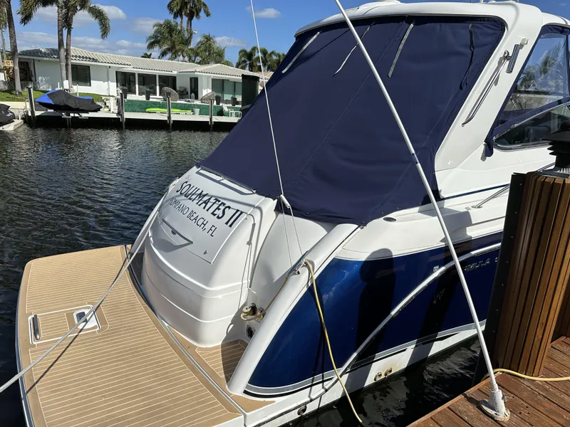 Slide: The Image of 2006 Formula 40 PC boat docked, featuring a blue and white exterior with covered cockpit. - 9