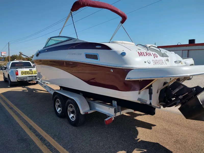 Slide: The Image of 2006 Crownline 270 BR boat on trailer, towed by truck with "Oversize Load" sign. - 1