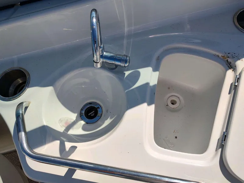 Slide: The Image of Crownline 270 BR 2006 boat sink and storage compartment. - 11