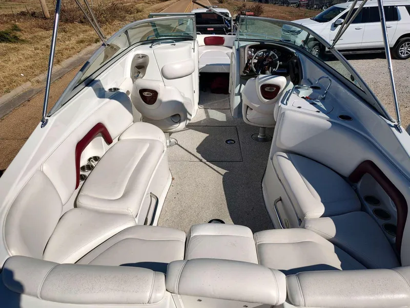 Slide: The Image of 2006 Crownline 270 BR boat interior with white seating and steering wheel. - 2