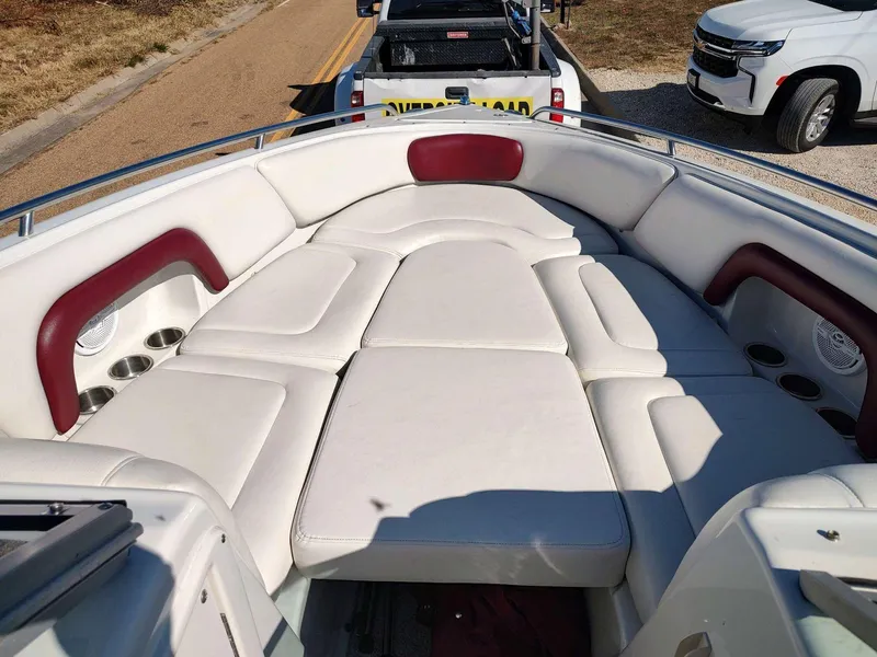 Slide: The Image of 2006 Crownline 270 BR boat with spacious white and red cushioned seating area. - 4
