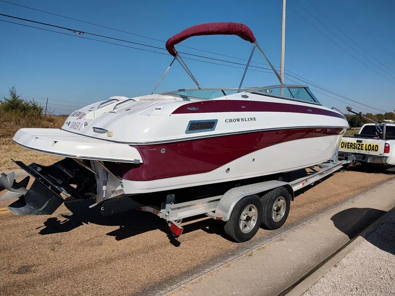 Slide: The Image of 2006 Crownline 270 BR boat on trailer, red and white design, sunny day. - 7